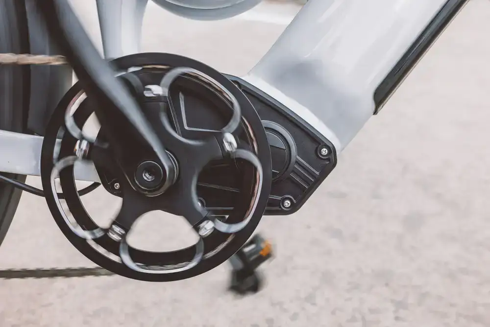Technician carefully adjusting the gears of a modern electric bike